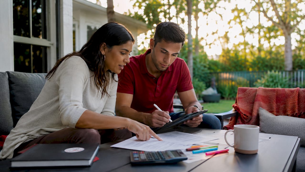 Couple reviewing mortgage contingency documents at home